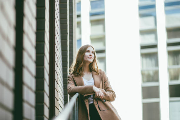 Young businesswoman day dreaming.