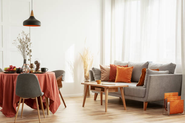 istock Open space dining and living area with grey scandinavian sofa and table with chairs 1161176463