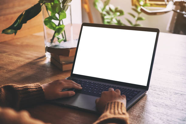 istock a woman using and typing on laptop with blank white desktop screen 1161176602