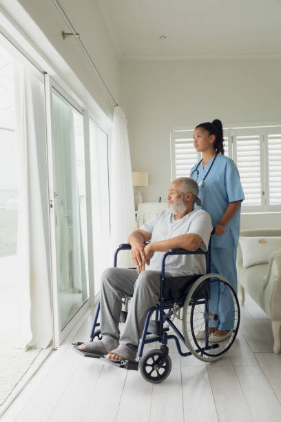 istock Healthcare worker and man on wheelchair 1161177832