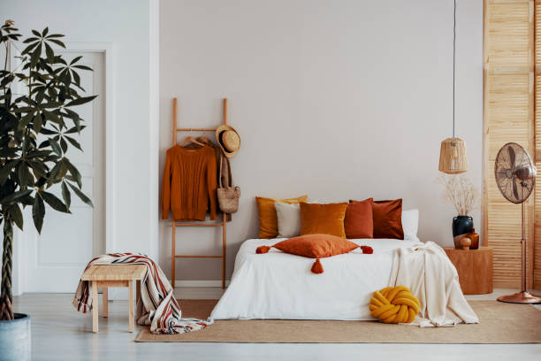 istock Copy space on empty white wall of natural bright bedroom interior 1161178010