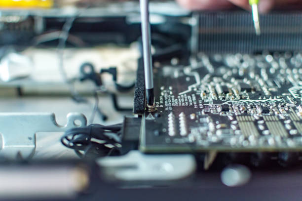 istock a man repairs a computer, solders a board, repairs electronics and modern technologies 1161180640
