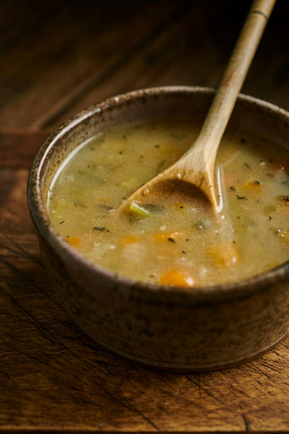 istock Chicken and vegetable soup in a rustic bowl with wooden spoon. 1161181257