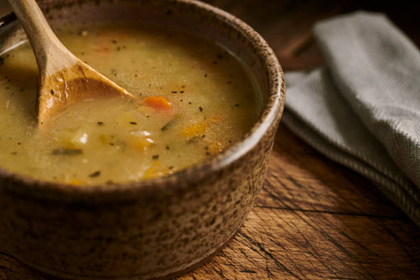 istock Chicken and vegetable soup in a rustic bowl with wooden spoon. 1161181264