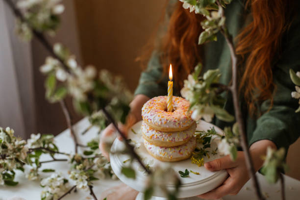 istock Lit candle in a beautiful donut 1161181904