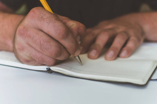 istock a person makes an entry in a notebook for doing business 1161181948