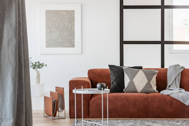 istock White metal coffee table next to comfortable couch with pillows 1161182797