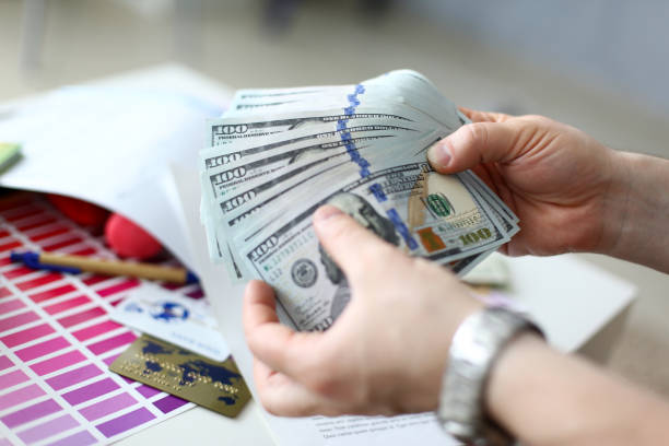 istock Male hands counting money from huge pack 1161183454