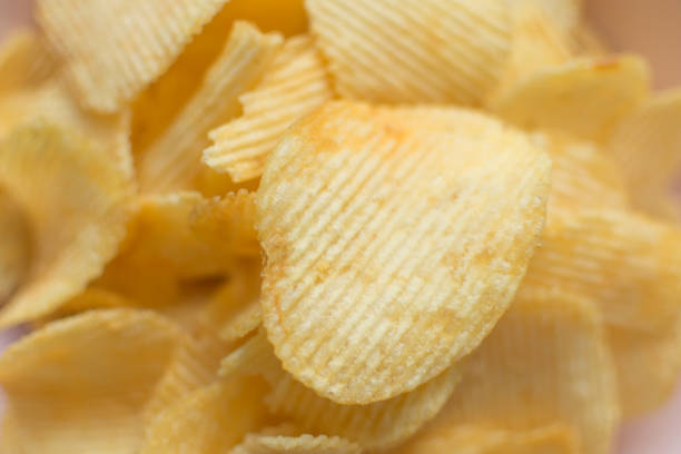 istock Heap of ribbed potato crisps. 1161184147