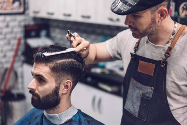 istock Young man getting stylish haircut 1161185132
