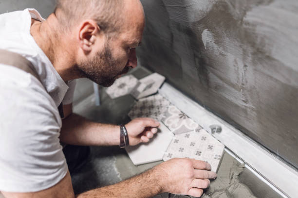 istock Builder installing hexagon tiles on the bathroom floor 1161185142