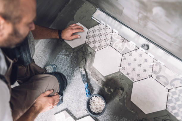 istock Male builder installing ceramic tiles in the bathroom 1161185149