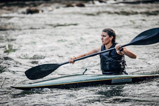 istock Woman kayaker paddling in river 1161185162