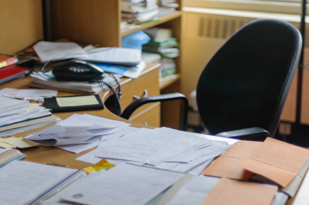 istock Lots of paper on a desk showing a heavy workload 1161185651