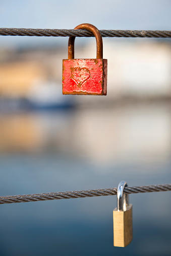 Love locks hanging on a steel cable of a bridge in the port of Rijeka (Croatia)