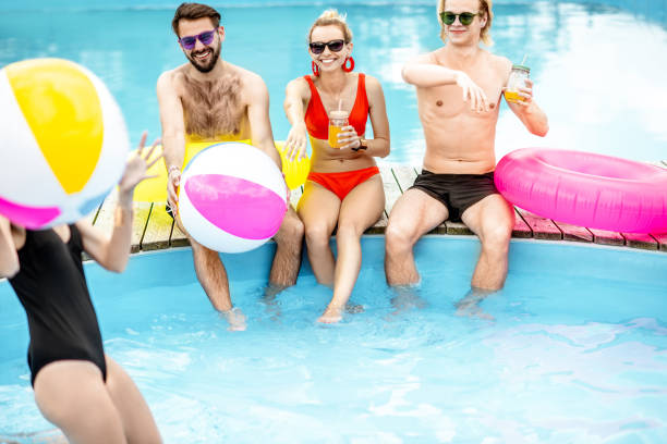 istock Friends having fun on the swimming pool 1161189778
