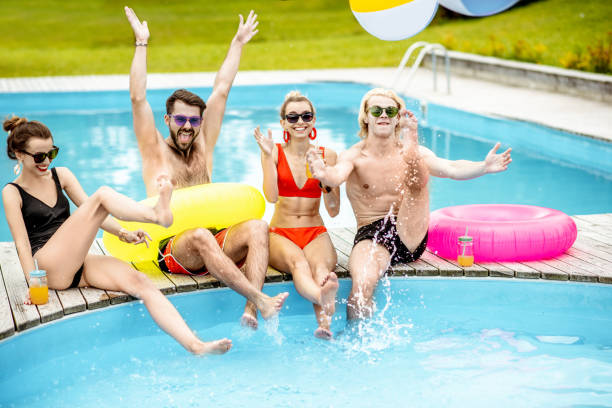 istock Friends having fun on the swimming pool 1161189834