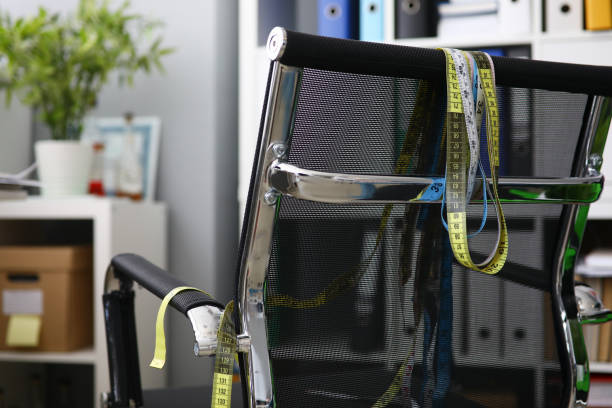 istock Measuring ribbons hanging on a black chair 1161189877