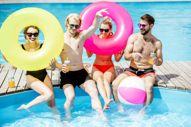 istock Friends having fun on the swimming pool 1161189989