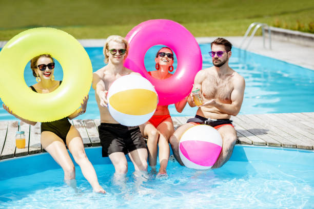 istock Friends having fun on the swimming pool 1161189999