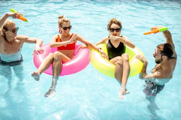 istock Friends playing in the swimming pool 1161190858