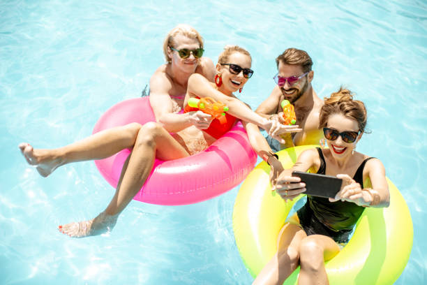 istock Friends playing in the swimming pool 1161190859