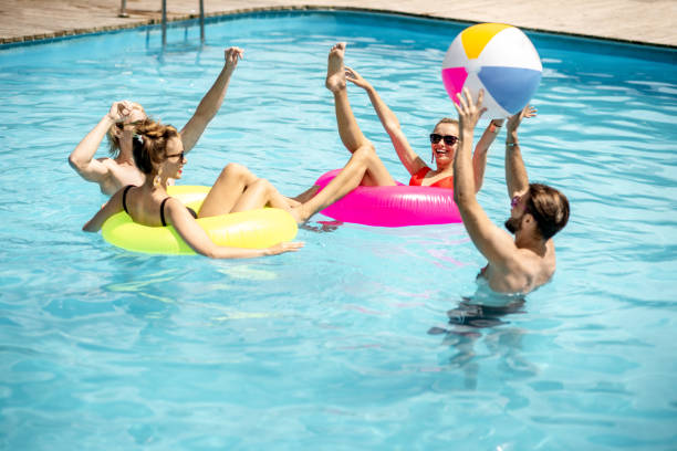 istock Friends playing in the swimming pool 1161190862