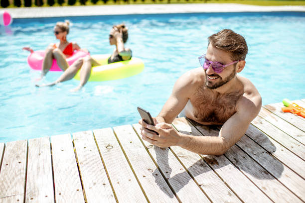 istock Man with phone in the swimming pool 1161191046