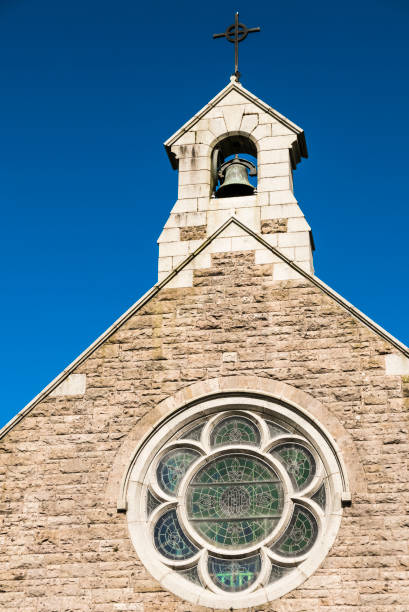 istock Bell tower of a Catholic Chapel, against a blue sky. 1161191495