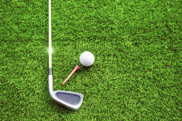 istock Golf balls and golf clubs on green grass 1161191502