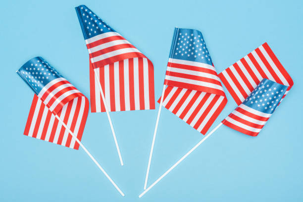 istock top view of satin american flags on sticks on blue background 1161191582