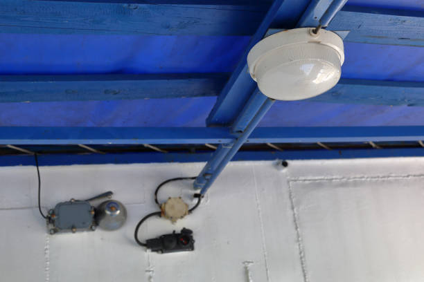 Old electric lamp on the ceiling of the garage