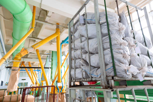 istock Factory and industrial concept. Stacked sacks against technological equipment pipes at modern pharmaceutical factory plant 1161192703