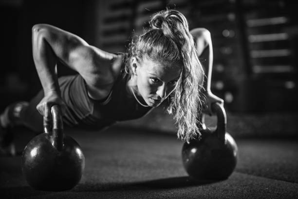 istock Woman athlete exercising with kettlebell 1161193750