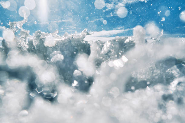 istock wave breaking over the camera lens on a bright sunny day. 1161193866