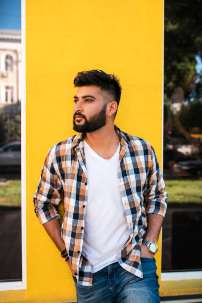 istock Handsome young indian man posing at street. 1161195343