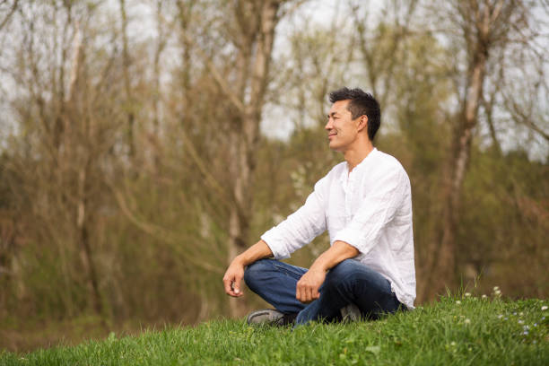 istock Japanese man sitting in nature 1161195536