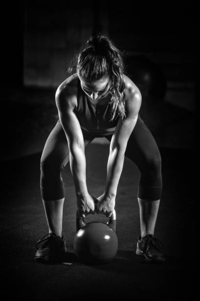 istock Woman athlete exercising with kettlebell 1161196530
