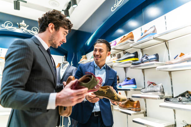 istock Handsome shop assistants helping to customer 1161197164