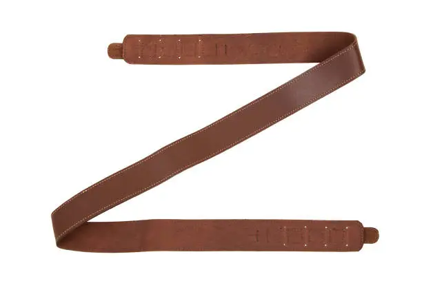 Photo of Brown leather shoulder strap for a gun isolated on white background