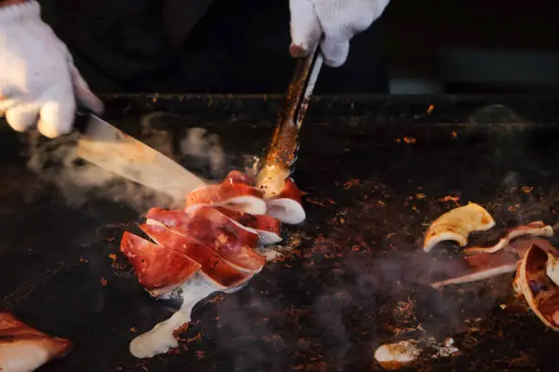Photo of Chef cooking ikayaki - Japanese grilled squid