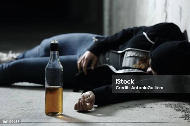 Drunk Girl Sleeping On The Floor In A Garage Stock Photo - Download Image Now - Drunk, Child, Alcohol - Drink