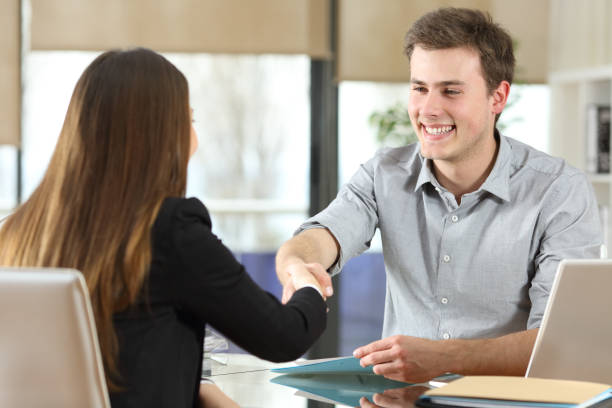 istock Happy businesspeople handshaking at office 1161199344