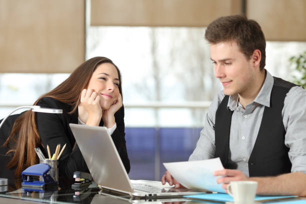 Businesswoman falling in love with a colleague Businesswoman falling in love with a colleague work romance stock pictures, royalty-free photos & images