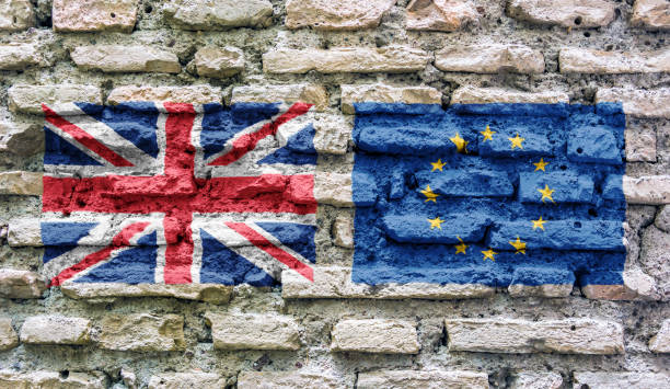 the flag of england and the european union imprinted on an old ruined brick wall - european union flag european community photography textured effect imagens e fotografias de stock