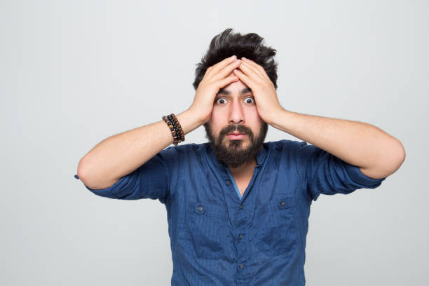 istock Portrait of shocked young man over grey background 1161201028