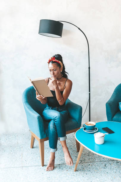 istock Beautiful woman reading book in cafe 1161207571