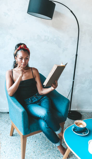 istock Beautiful woman reading book in cafe 1161207574