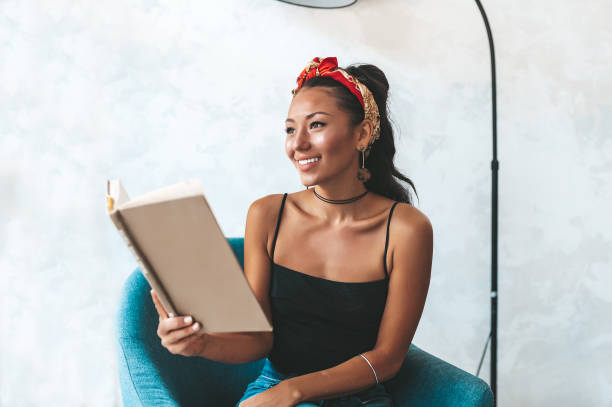 istock Beautiful woman reading book in cafe 1161207612