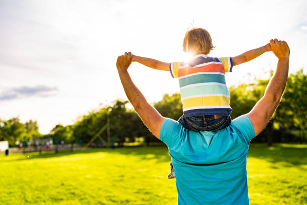 istock Rear view father carrying on shoulders small boy 1161208658